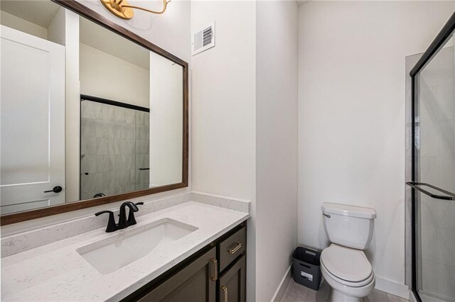 12445 Empress St, Platte City, MO 64079 - bathroom featuring vanity, baseboards, toilet, and a stall shower