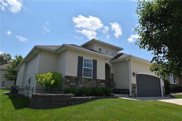 2015 Creek View Ln, Raymore, MO 64083 - prairie-style house featuring stucco siding, a garage, stone siding, and concrete driveway