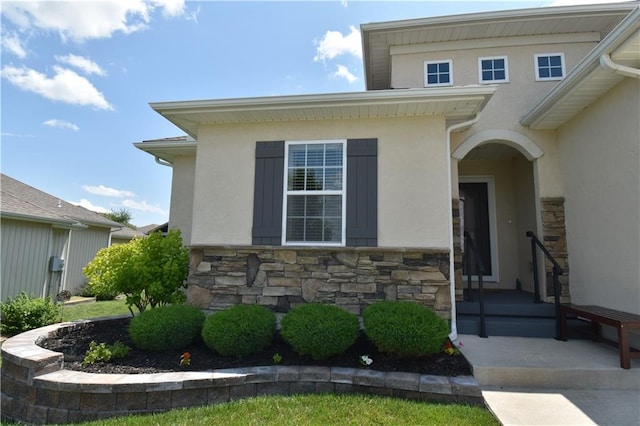 2015 Creek View Ln, Raymore, MO 64083 - doorway to property featuring stone siding and stucco siding