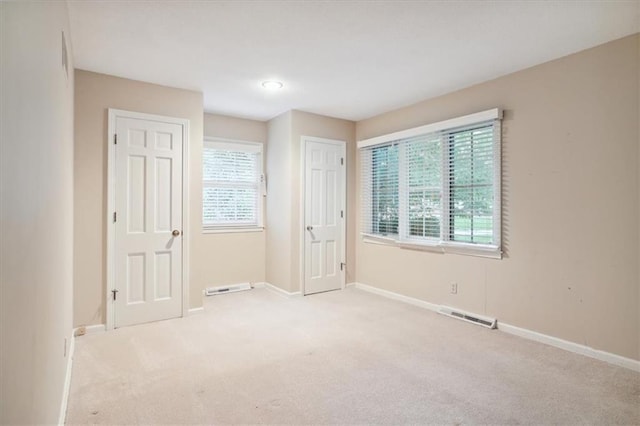 126 W 116th St, Kansas City, MO 64114 - empty room with carpet flooring and plenty of natural light