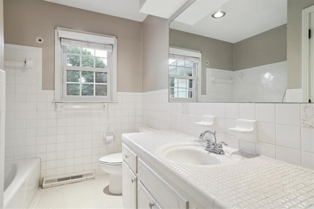 126 W 116th St, Kansas City, MO 64114 - bathroom with tile walls, vanity, a tub to relax in, tile patterned flooring, and baseboard heating