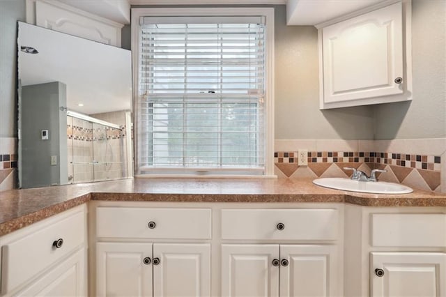 126 W 116th St, Kansas City, MO 64114 - kitchen with decorative backsplash, white cabinetry, and dark countertops