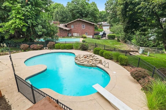 126 W 116th St, Kansas City, MO 64114 - view of pool featuring a diving board and view of wooded area