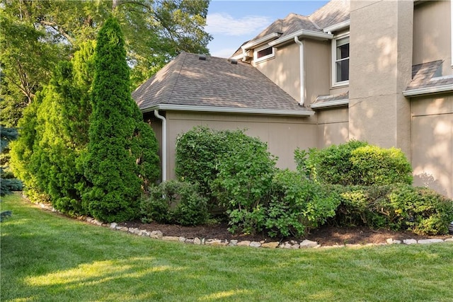 2201 SW Forestpark Cir, Lees Summit, MO 64081 - view of property exterior featuring a yard, roof with shingles, and stucco siding