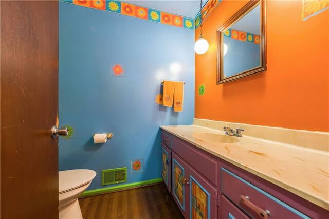 9714 Shepherds Dr, Kansas City, MO 64131 - bathroom featuring vanity, toilet, wood finished floors, and baseboards