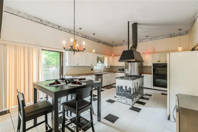 9714 Shepherds Dr, Kansas City, MO 64131 - kitchen featuring ventilation hood, stainless steel appliances, a sink, a chandelier, and plenty of natural light