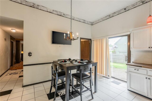 9714 Shepherds Dr, Kansas City, MO 64131 - dining room with light tile patterned floors and a chandelier