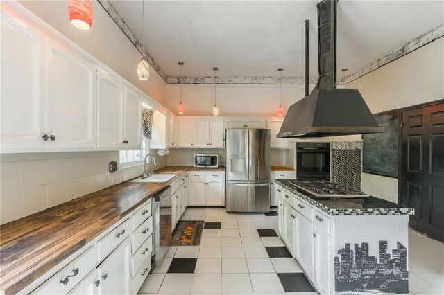 9714 Shepherds Dr, Kansas City, MO 64131 - kitchen featuring appliances with stainless steel finishes, a sink, wooden counters, and tasteful backsplash