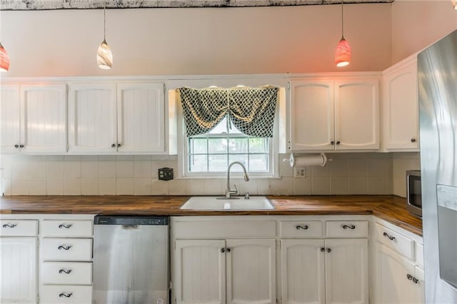 9714 Shepherds Dr, Kansas City, MO 64131 - kitchen with wooden counters, stainless steel appliances, a sink, and tasteful backsplash