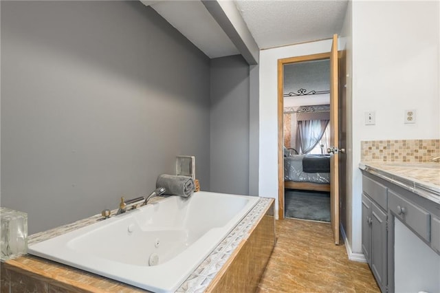 9714 Shepherds Dr, Kansas City, MO 64131 - ensuite bathroom with vanity, a jetted tub, and a textured ceiling