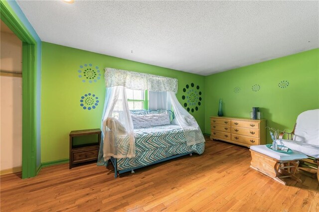 9714 Shepherds Dr, Kansas City, MO 64131 - bedroom featuring a textured ceiling and wood finished floors