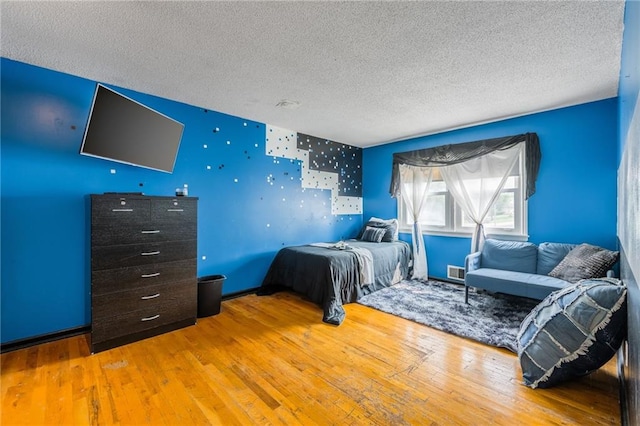 9714 Shepherds Dr, Kansas City, MO 64131 - bedroom with a textured ceiling and wood-type flooring