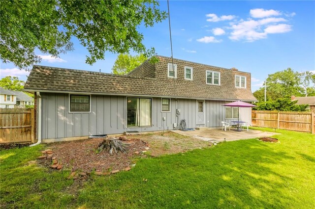 9714 Shepherds Dr, Kansas City, MO 64131 - rear view of house with board and batten siding, a shingled roof, a patio, and mansard roof