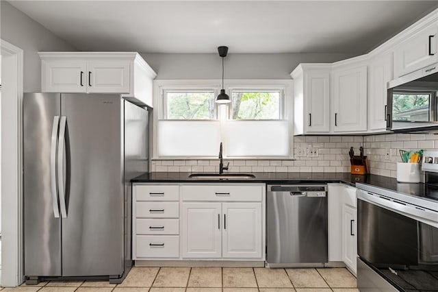 10417 Outlook Dr, Overland Park, KS 66207 - kitchen featuring appliances with stainless steel finishes, dark countertops, white cabinetry, and tasteful backsplash