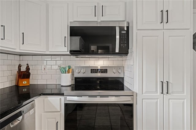 10417 Outlook Dr, Overland Park, KS 66207 - kitchen featuring appliances with stainless steel finishes, white cabinetry, tasteful backsplash, and tile patterned flooring