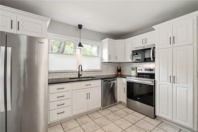 10417 Outlook Dr, Overland Park, KS 66207 - kitchen featuring stainless steel appliances, dark countertops, decorative backsplash, light tile patterned floors, and white cabinetry