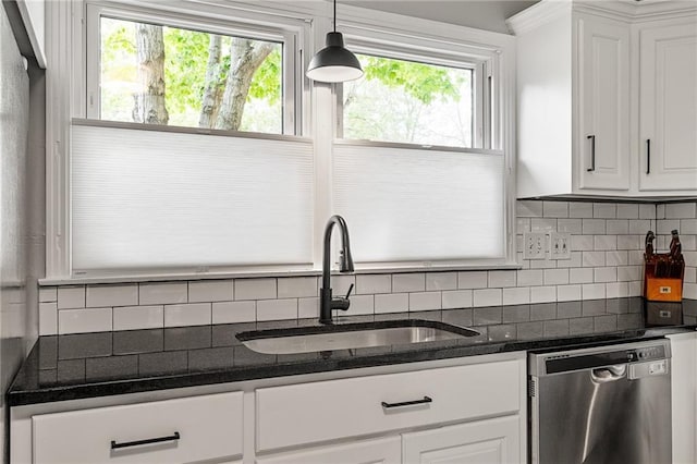 10417 Outlook Dr, Overland Park, KS 66207 - kitchen with stainless steel dishwasher, decorative backsplash, white cabinetry, and decorative light fixtures