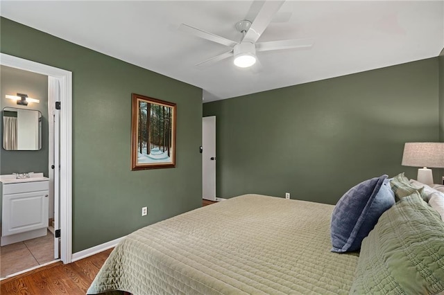 10417 Outlook Dr, Overland Park, KS 66207 - bedroom with wood finished floors, connected bathroom, and ceiling fan