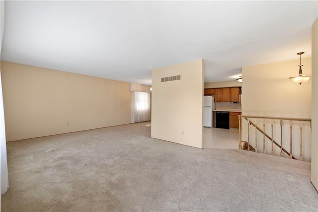 5029 NE 58th St, Kansas City, MO 64119 - unfurnished living room with light colored carpet