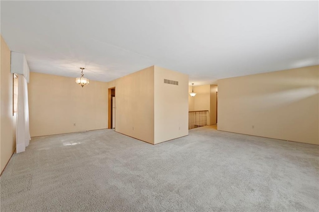 5029 NE 58th St, Kansas City, MO 64119 - spare room with a chandelier and light colored carpet