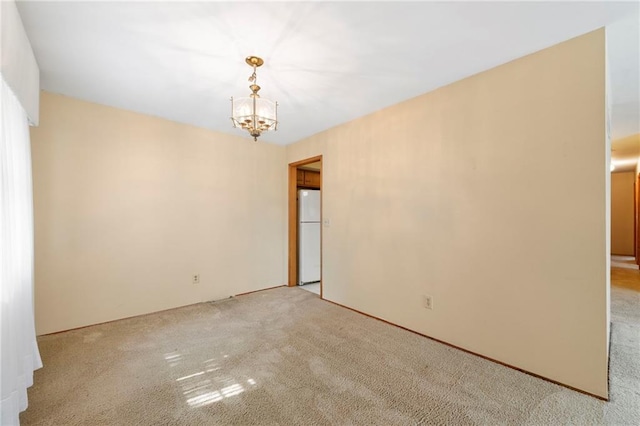5029 NE 58th St, Kansas City, MO 64119 - carpeted spare room with a chandelier