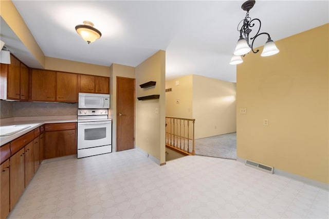 5029 NE 58th St, Kansas City, MO 64119 - kitchen featuring white microwave, wall oven, light floors, and brown cabinets