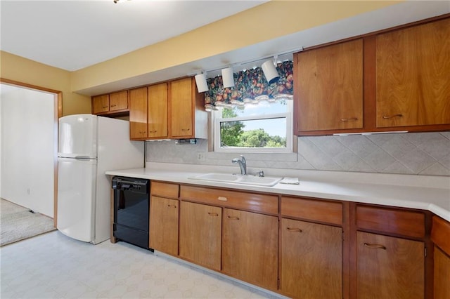5029 NE 58th St, Kansas City, MO 64119 - kitchen featuring black dishwasher, light flooring, light countertops, and brown cabinetry