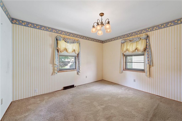5029 NE 58th St, Kansas City, MO 64119 - spare room featuring a chandelier, carpet floors, and wallpapered walls