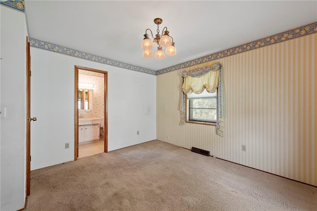 5029 NE 58th St, Kansas City, MO 64119 - carpeted spare room featuring a chandelier