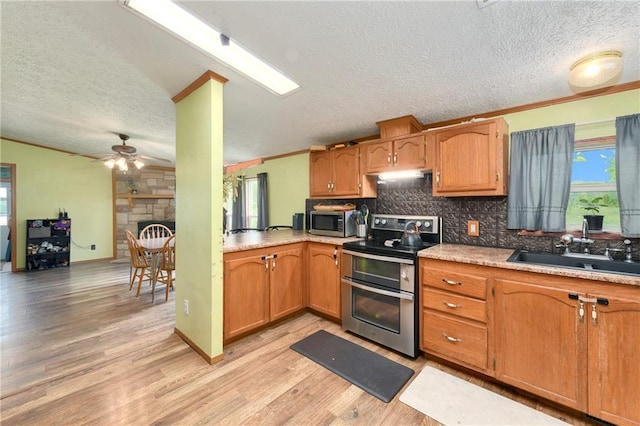 46005 E State Route N, Creighton, MO 64739 - kitchen featuring appliances with stainless steel finishes, light wood finished floors, a textured ceiling, ceiling fan, and tasteful backsplash