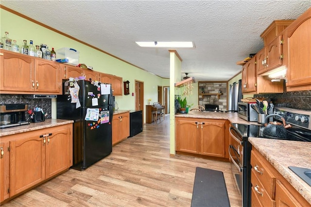 46005 E State Route N, Creighton, MO 64739 - kitchen with stainless steel appliances, crown molding, light wood-type flooring, backsplash, and light countertops