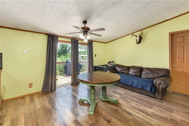 46005 E State Route N, Creighton, MO 64739 - living area featuring ceiling fan, ornamental molding, a textured ceiling, wood finished floors, and baseboards