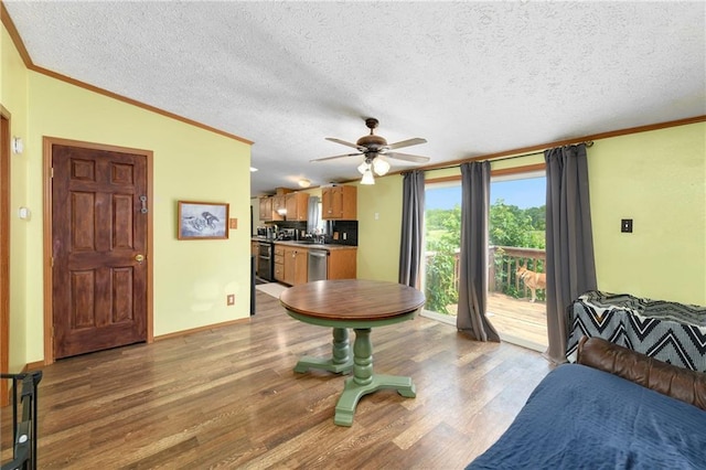 46005 E State Route N, Creighton, MO 64739 - dining space featuring light wood-type flooring, a ceiling fan, a textured ceiling, crown molding, and lofted ceiling