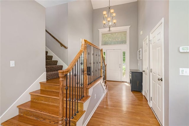 5827 Roundtree St, Shawnee, KS 66226 - entrance foyer with a towering ceiling, stairs, a chandelier, and light wood-type flooring