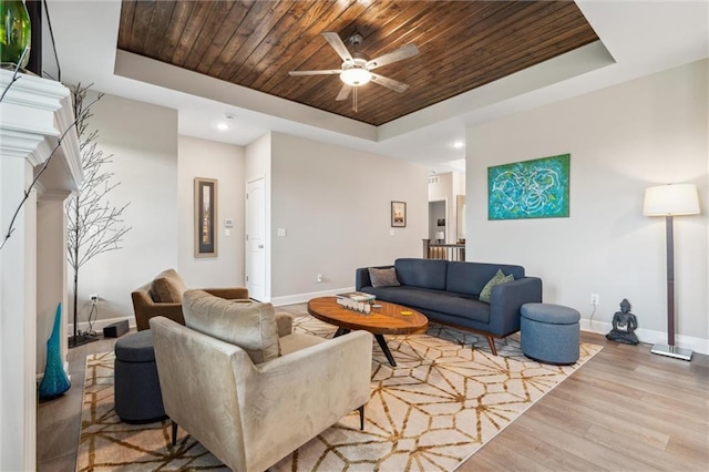 9504 N Amoret Ave, Kansas City, MO 64154 - living room featuring a raised ceiling, wood ceiling, baseboards, wood finished floors, and recessed lighting
