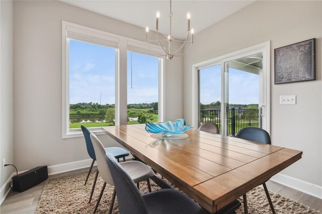 9504 N Amoret Ave, Kansas City, MO 64154 - dining space with a chandelier, healthy amount of natural light, baseboards, and light wood-style flooring