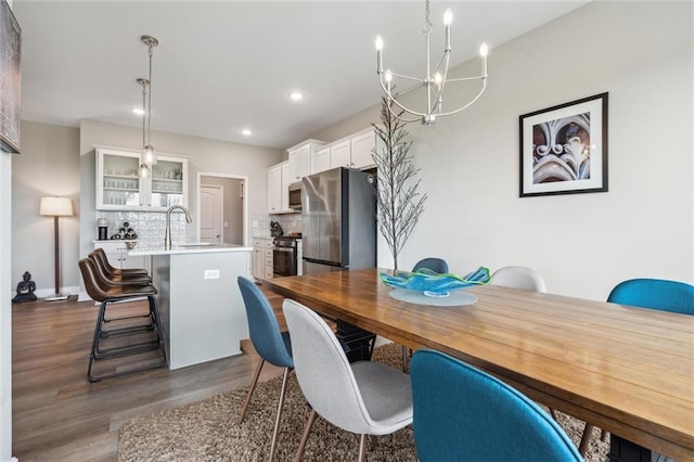 9504 N Amoret Ave, Kansas City, MO 64154 - dining area featuring a chandelier, dark wood-style floors, and recessed lighting