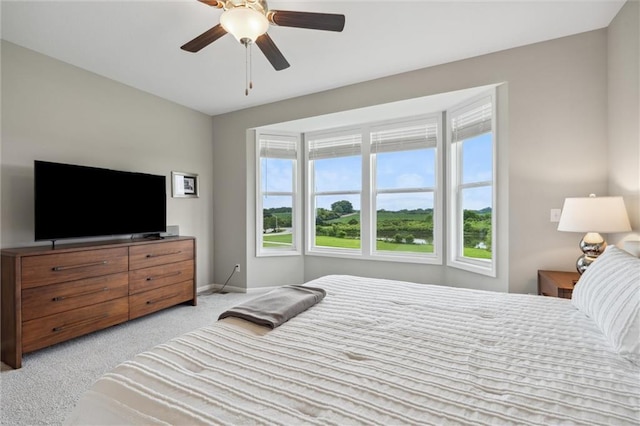 9504 N Amoret Ave, Kansas City, MO 64154 - bedroom with light carpet, baseboards, and a ceiling fan