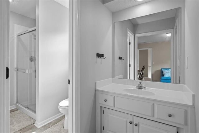 17631 S Brockway St, Olathe, KS 66062 - bathroom featuring a shower stall, vanity, a textured ceiling, tile patterned floors, and ensuite bath