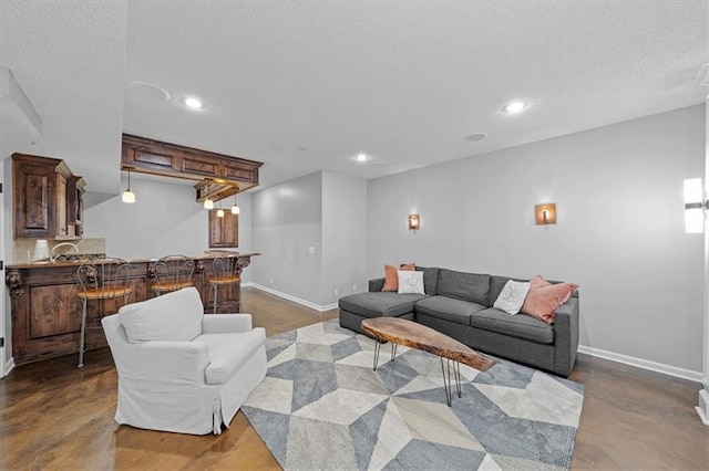 17631 S Brockway St, Olathe, KS 66062 - living room featuring a textured ceiling, recessed lighting, bar, and finished concrete flooring