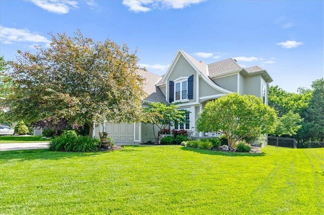 17631 S Brockway St, Olathe, KS 66062 - view of property exterior with a lawn and stucco siding
