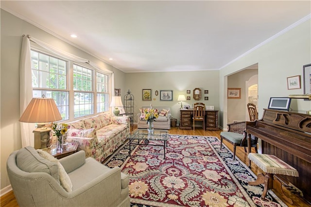 301 W 109th St, Kansas City, MO 64114 - living room featuring ornamental molding, wood finished floors, arched walkways, and recessed lighting