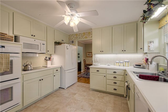 301 W 109th St, Kansas City, MO 64114 - kitchen with white appliances, light countertops, backsplash, ceiling fan, and crown molding