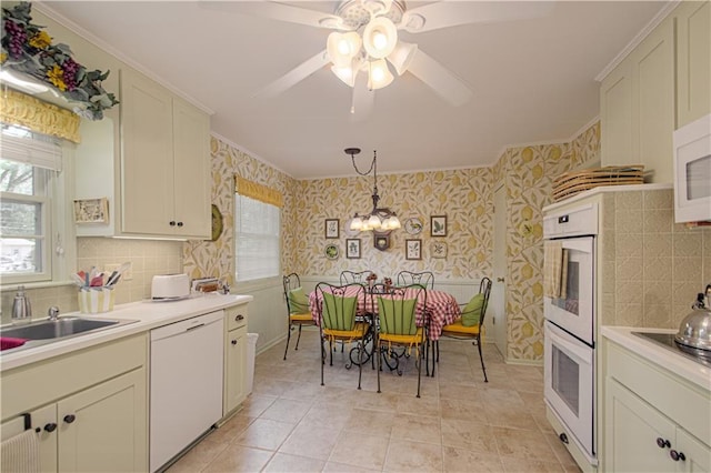 301 W 109th St, Kansas City, MO 64114 - kitchen with white appliances, wallpapered walls, ceiling fan, tasteful backsplash, and light countertops