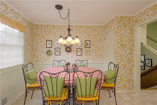 301 W 109th St, Kansas City, MO 64114 - dining area with wallpapered walls, ornamental molding, a chandelier, stairway, and a wainscoted wall