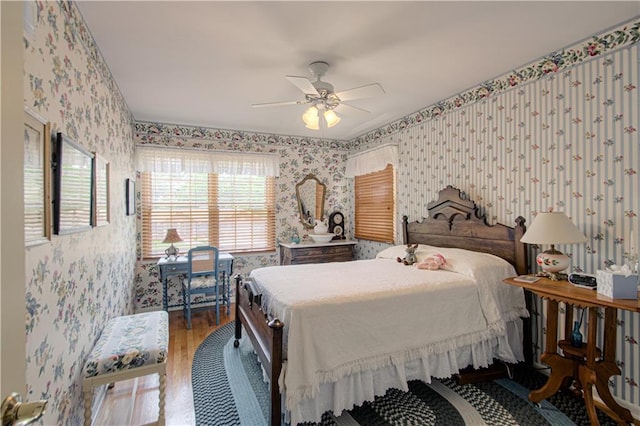 301 W 109th St, Kansas City, MO 64114 - bedroom featuring wallpapered walls, wood finished floors, and a ceiling fan