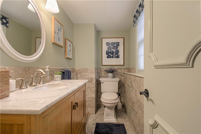 301 W 109th St, Kansas City, MO 64114 - bathroom featuring tile walls, vanity, and a wainscoted wall