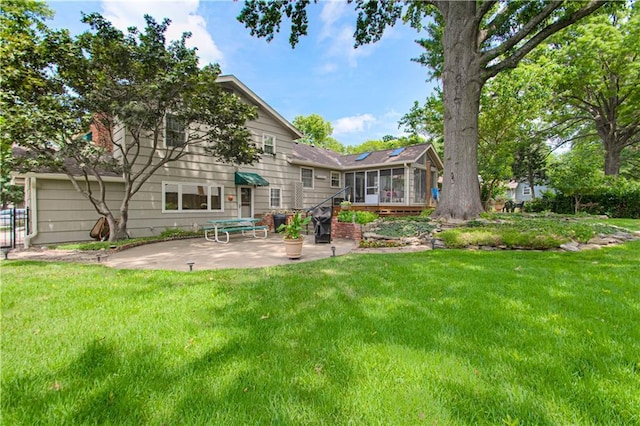 301 W 109th St, Kansas City, MO 64114 - rear view of property featuring a sunroom, a patio area, and a yard