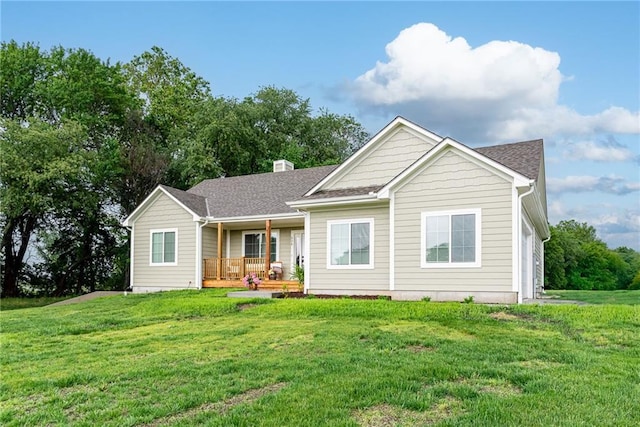 938 Mount Calvary Rd, Lansing, KS 66043 - rear view of house with a porch, a lawn, and a chimney