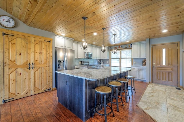 210 SE 200th Rd, Clinton, MO 64735 - kitchen with stainless steel appliances, wooden ceiling, white cabinets, light stone countertops, and recessed lighting